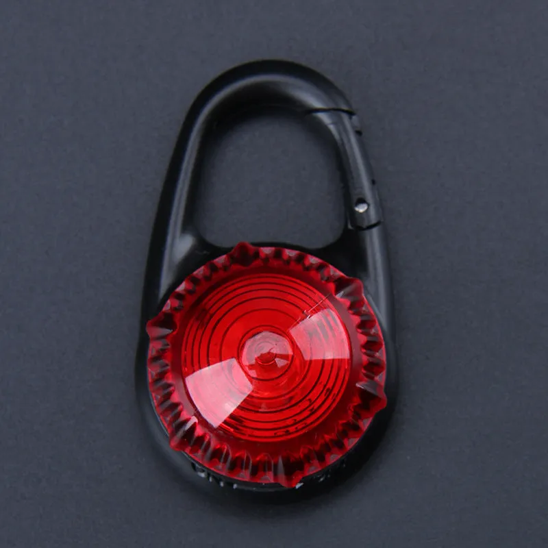 Pink LED flashing pet safety pendant clipped onto a collar with CR2032 batteries, showing 57x33mm ABS water-resistant build