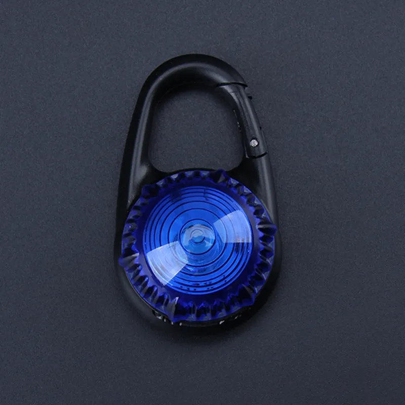 Pink LED flashing pet safety pendant clipped onto a collar with CR2032 batteries, showing 57x33mm ABS water-resistant build