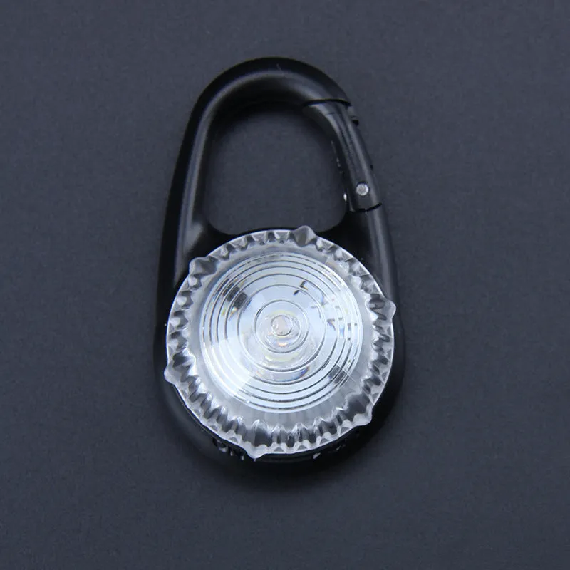 Pink LED flashing pet safety pendant clipped onto a collar with CR2032 batteries, showing 57x33mm ABS water-resistant build
