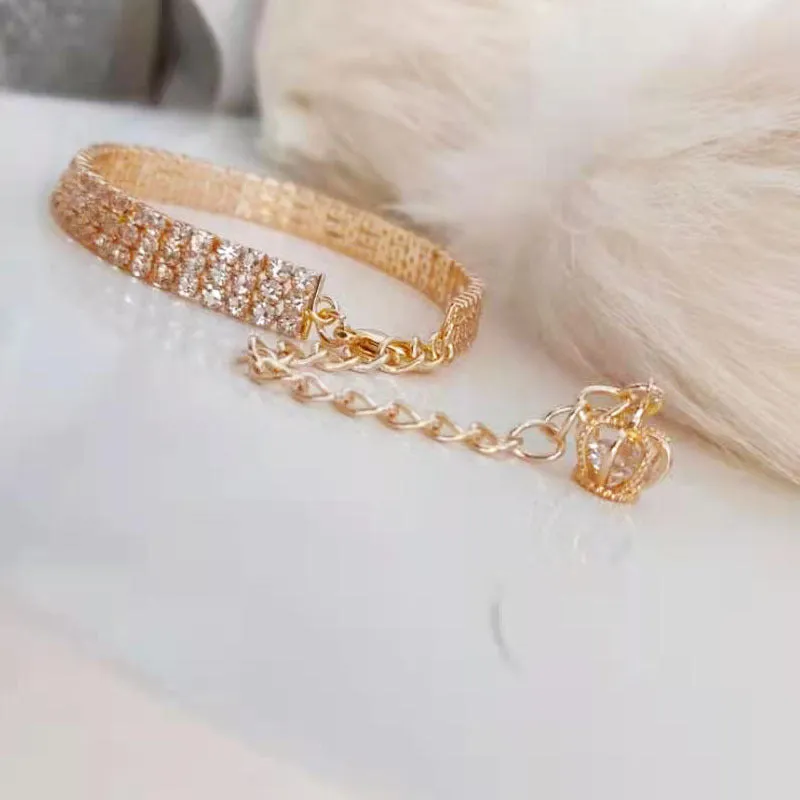 Gold dog collar with crown pattern and three drain diamond rhinestone detail on copper base