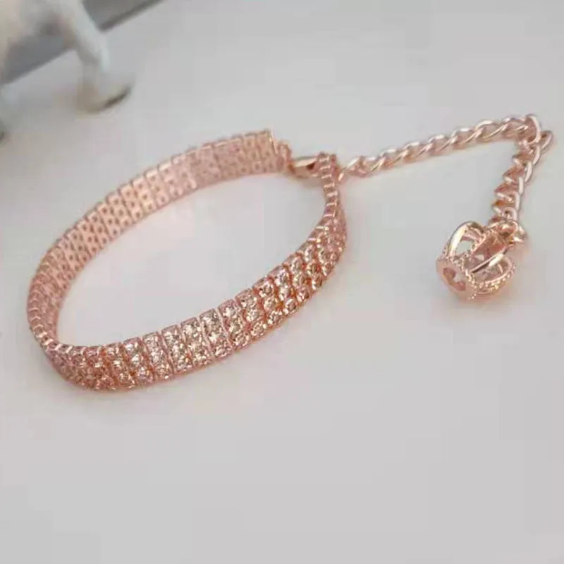 Gold dog collar with crown pattern and three drain diamond rhinestone detail on copper base