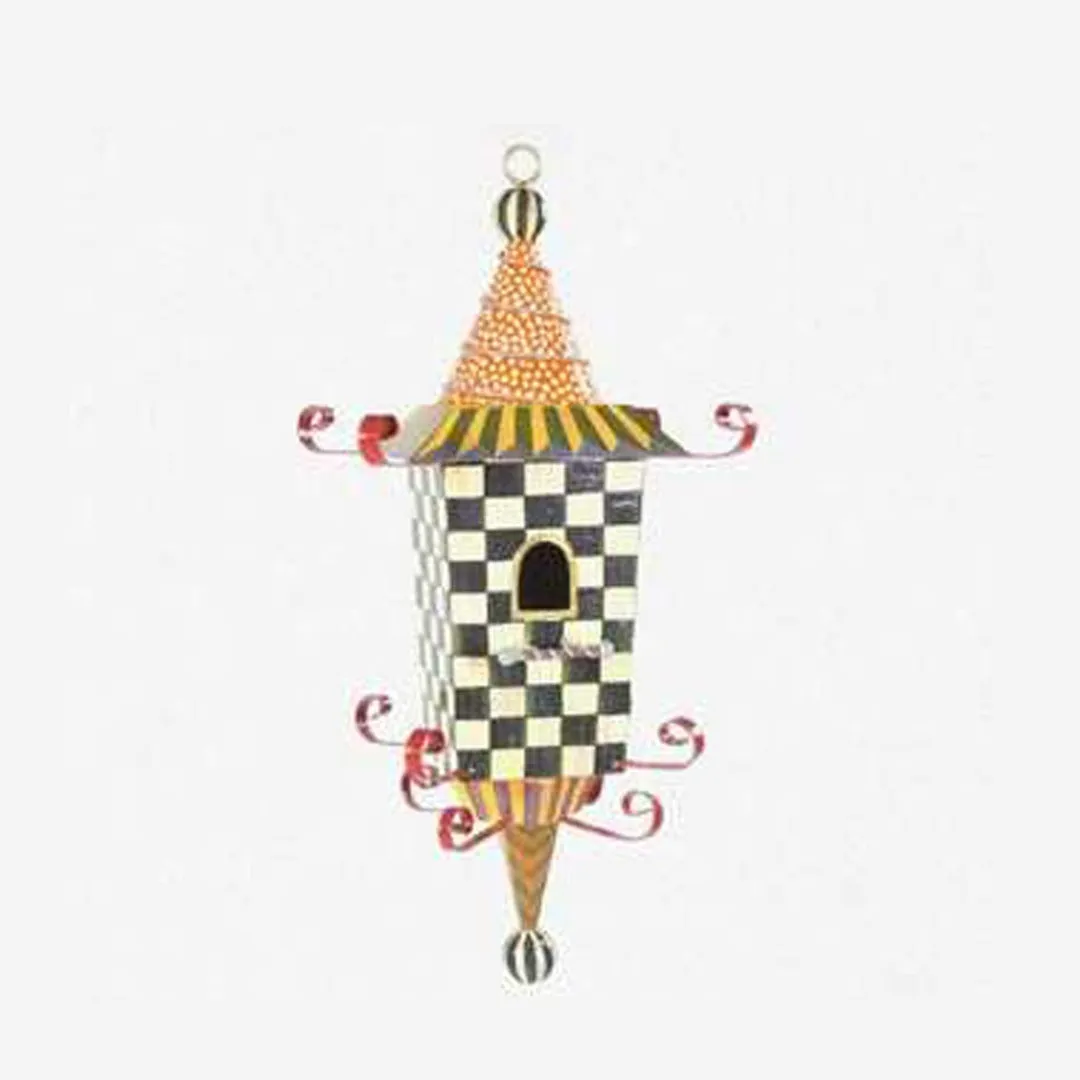 Iron metal bird feeder with creative pattern hanging from tree branch in garden