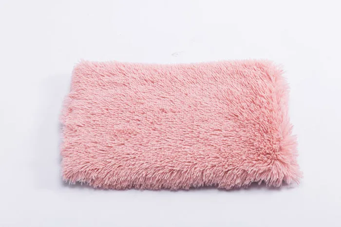 Plush pet nest with non-slip base, water-resistant material, available in multiple sizes and colours