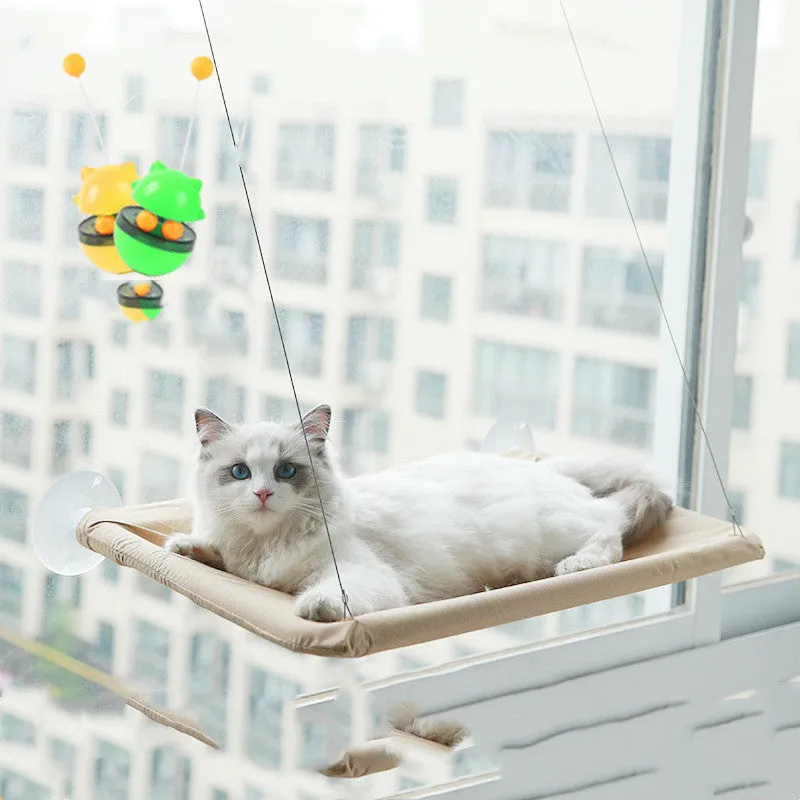 Blue cat hammock with suction cups attached to a window, featuring breathable fabric and metal frame