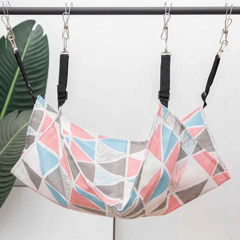 Blue cat hammock with suction cups attached to a window, featuring breathable fabric and metal frame