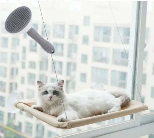 Blue cat hammock with suction cups attached to a window, featuring breathable fabric and metal frame