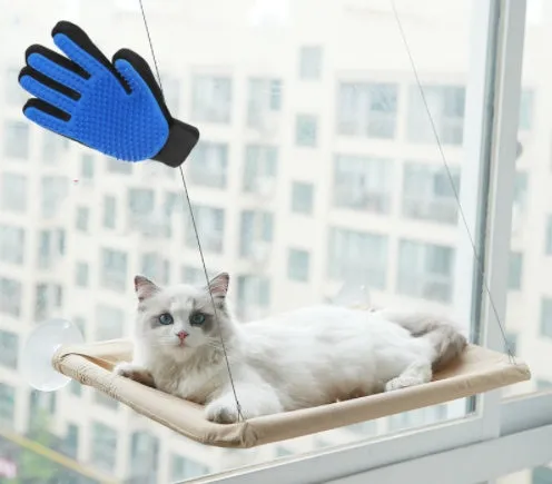 Blue cat hammock with suction cups attached to a window, featuring breathable fabric and metal frame