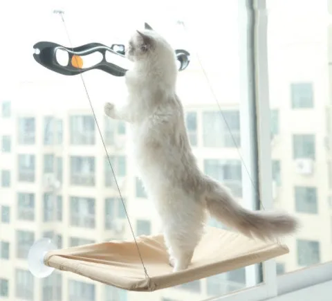 Blue cat hammock with suction cups attached to a window, featuring breathable fabric and metal frame