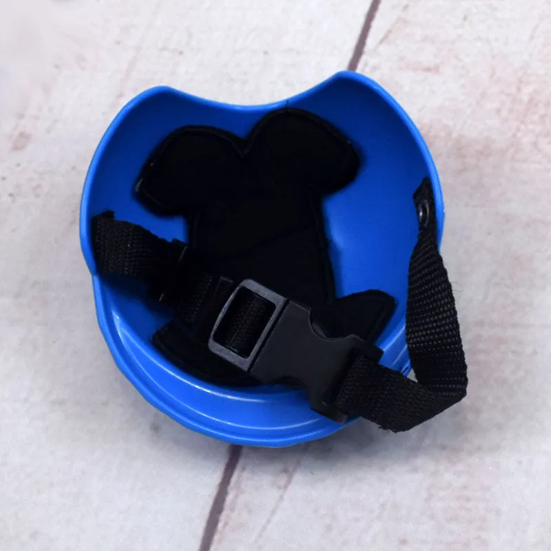A pink plastic dog hat designed like a motorcycle helmet on a white background.