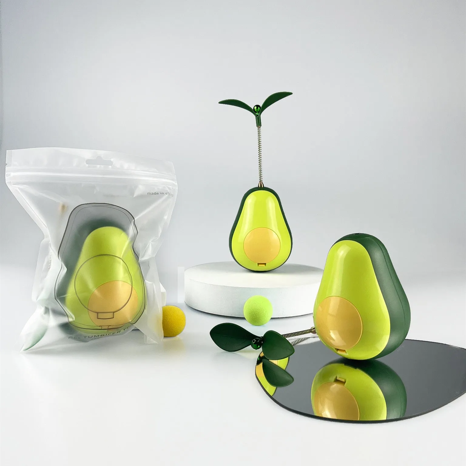 Green silicone avocado-shaped cat toy tumbler with treat dispensing opening, 80x80x107mm size