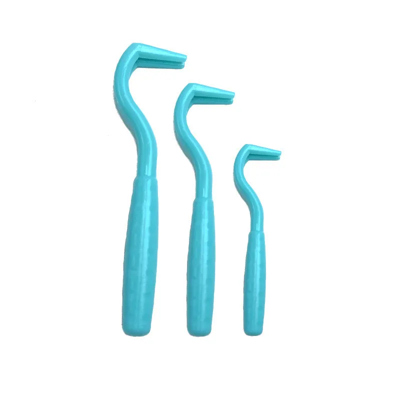 Set of three coloured plastic tick removal hooks for dogs on a white background.