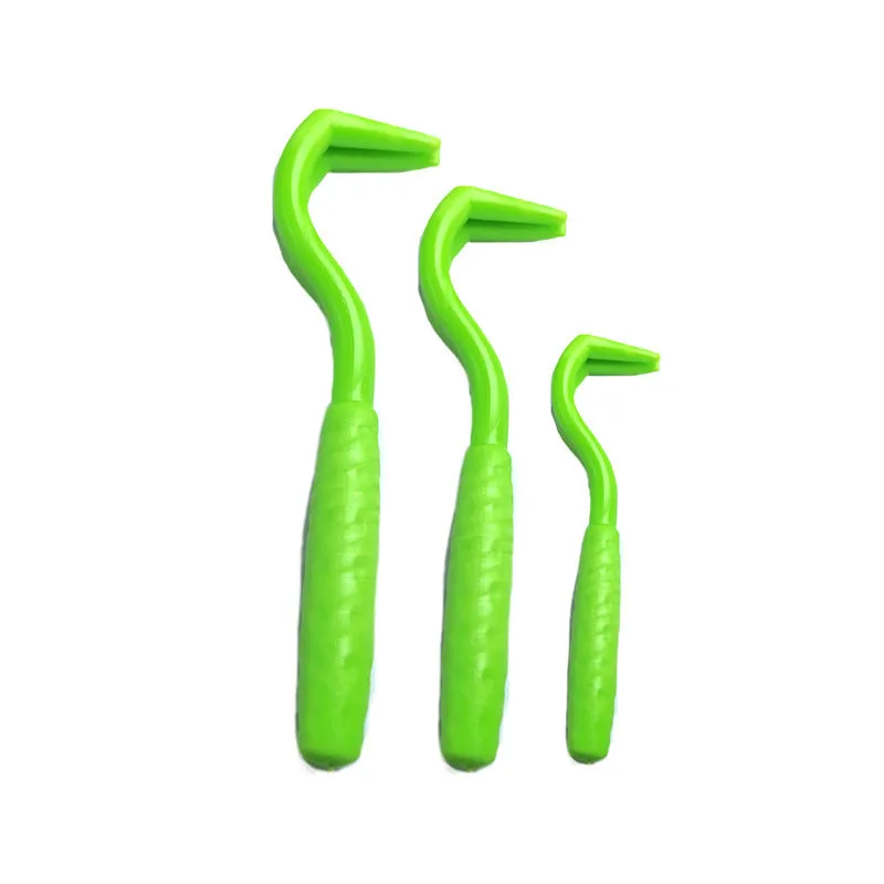 Set of three coloured plastic tick removal hooks for dogs on a white background.