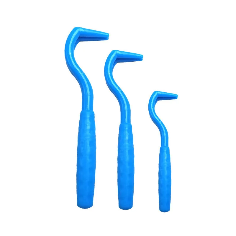 Set of three coloured plastic tick removal hooks for dogs on a white background.