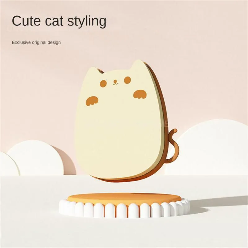 Brown sponge silicone pet hair removal brush with comb teeth on a wooden surface