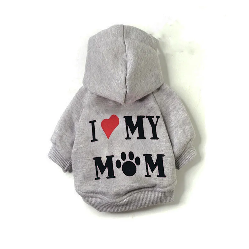 Small grey dog wearing a fleece pet sweater with hood, shown on a grassy area