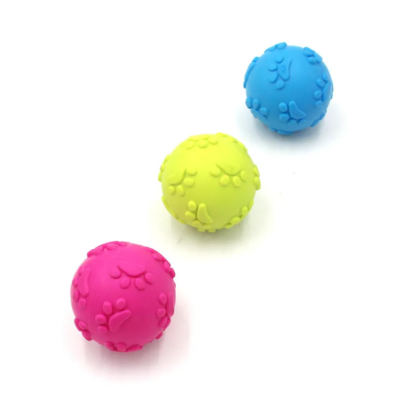 Blue TPR dog bite proof toy ball with built-in soundtrack, 6cm diameter on grass