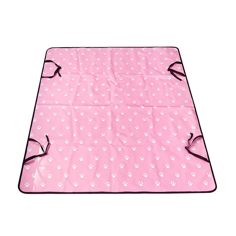 Water resistant dog car seat cover mat on a rear car seat in a bone print pattern.