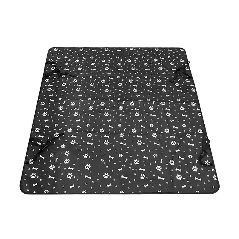 Water resistant dog car seat cover mat on a rear car seat in a bone print pattern.