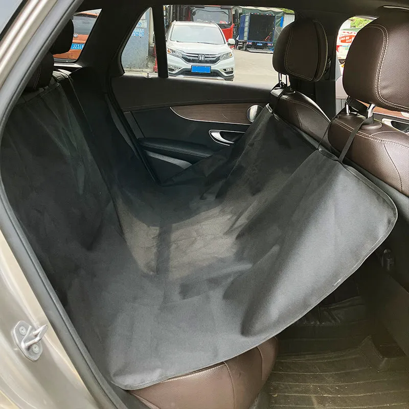 Water resistant dog car seat cover mat on a rear car seat in a bone print pattern.