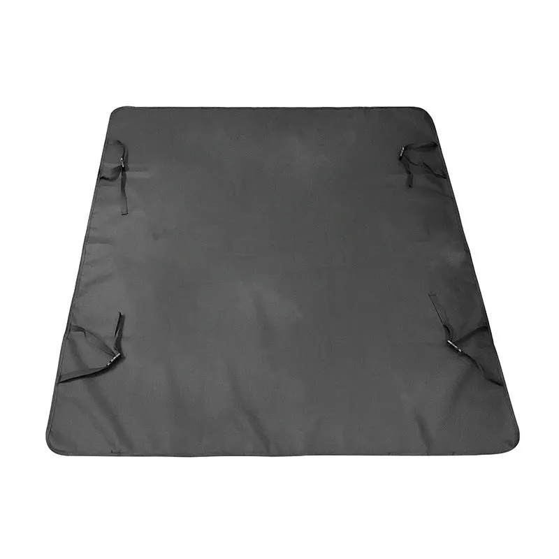 Water resistant dog car seat cover mat on a rear car seat in a bone print pattern.