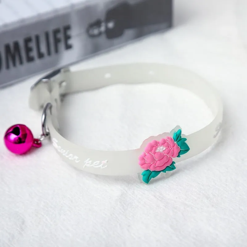 Silicone light-up cat collar with luminous fish bone and heart patterns on a pink background