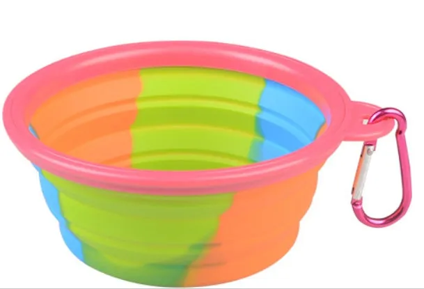 Collapsible silicone dog bowl in camouflage pattern folded flat on green surface