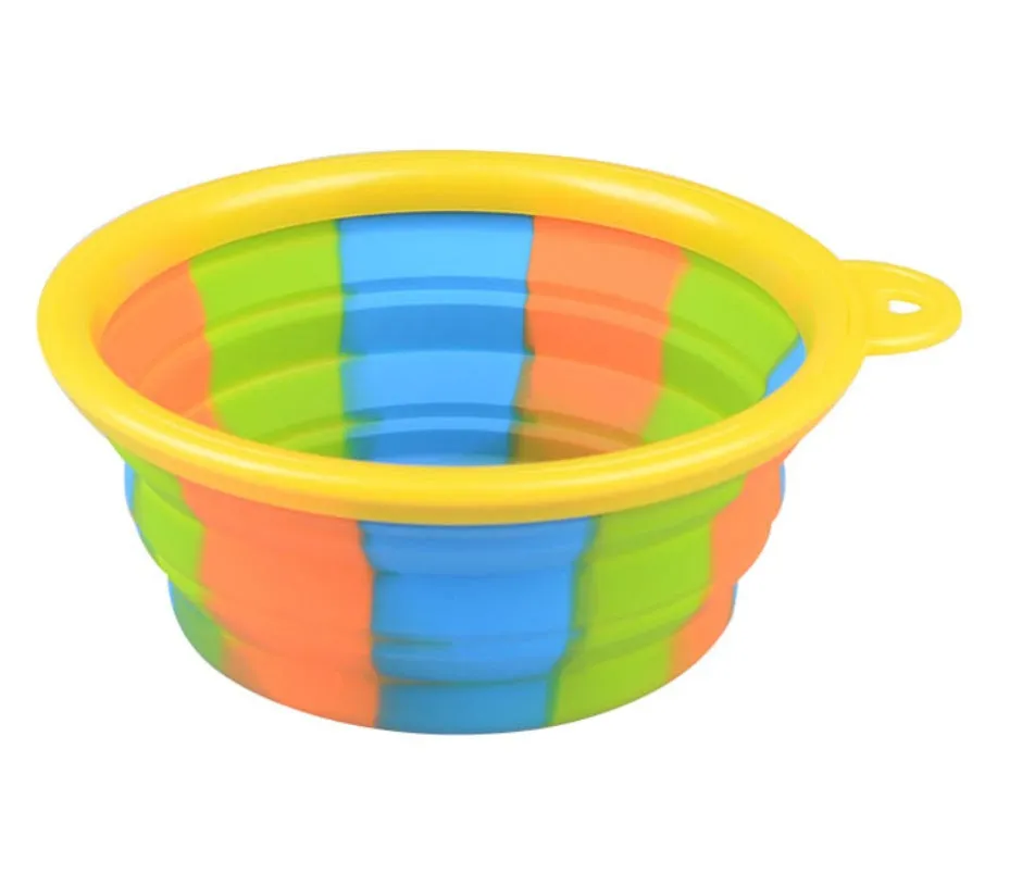 Collapsible silicone dog bowl in camouflage pattern folded flat on green surface