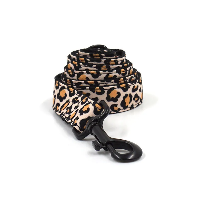Brown leopard print dog collar and leash set with black buckle on a green background