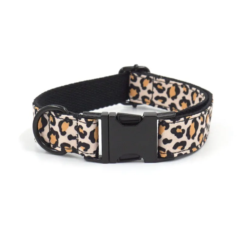 Brown leopard print dog collar and leash set with black buckle on a green background