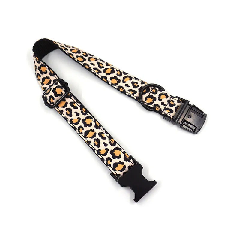 Brown leopard print dog collar and leash set with black buckle on a green background