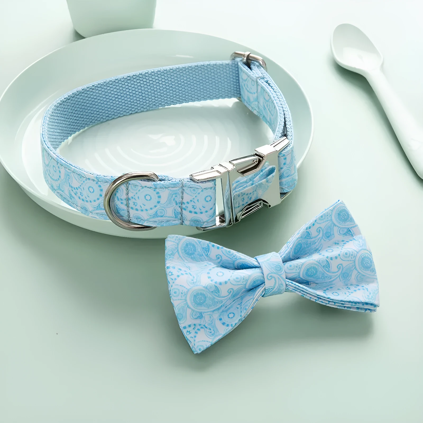 Paisley polyester dog collar with zinc alloy buckle and lettering on a white background.