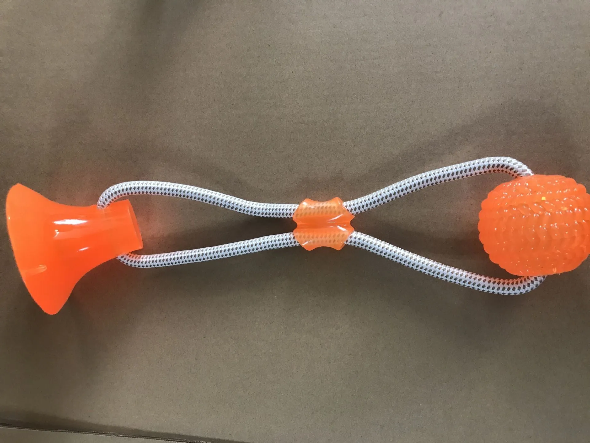 Pet dog rubber sucker molar toy in five colours blue green orange purple red on a light background