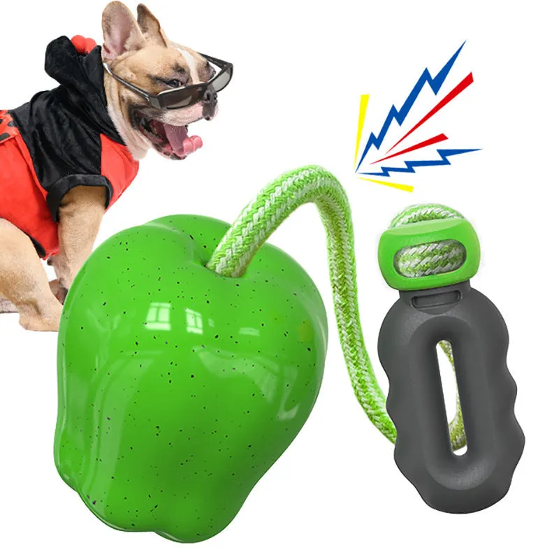 Green and red plastic Apple-shaped dog toy with a slot for dog food and a squeaker inside.