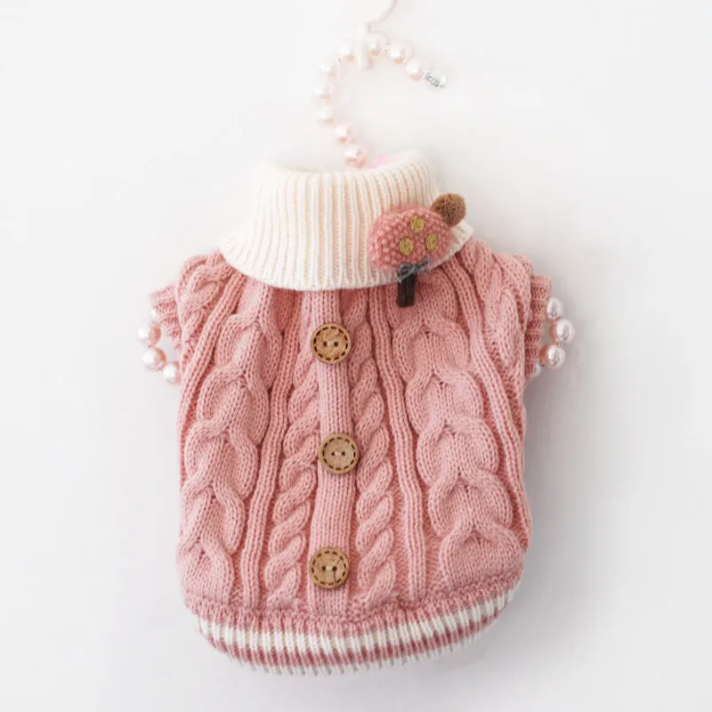 Classic knitted pet sweater in pink for small dogs, with twist button closure, on a white background