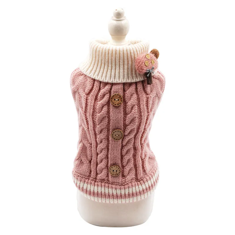 Classic knitted pet sweater in pink for small dogs, with twist button closure, on a white background