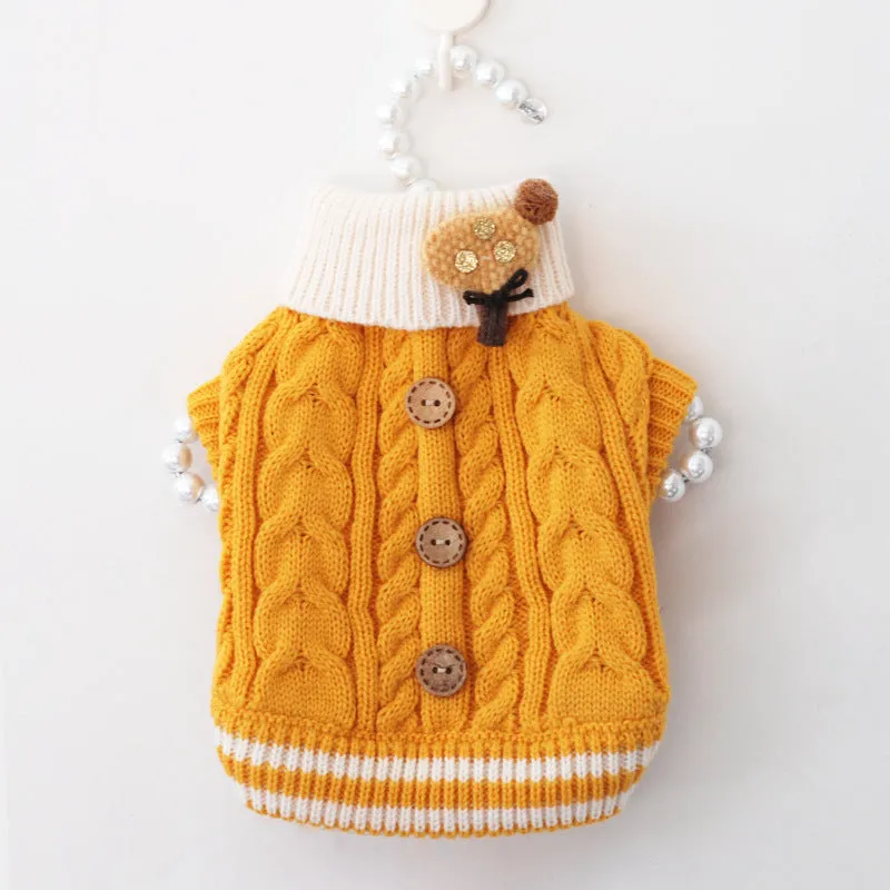Classic knitted pet sweater in pink for small dogs, with twist button closure, on a white background