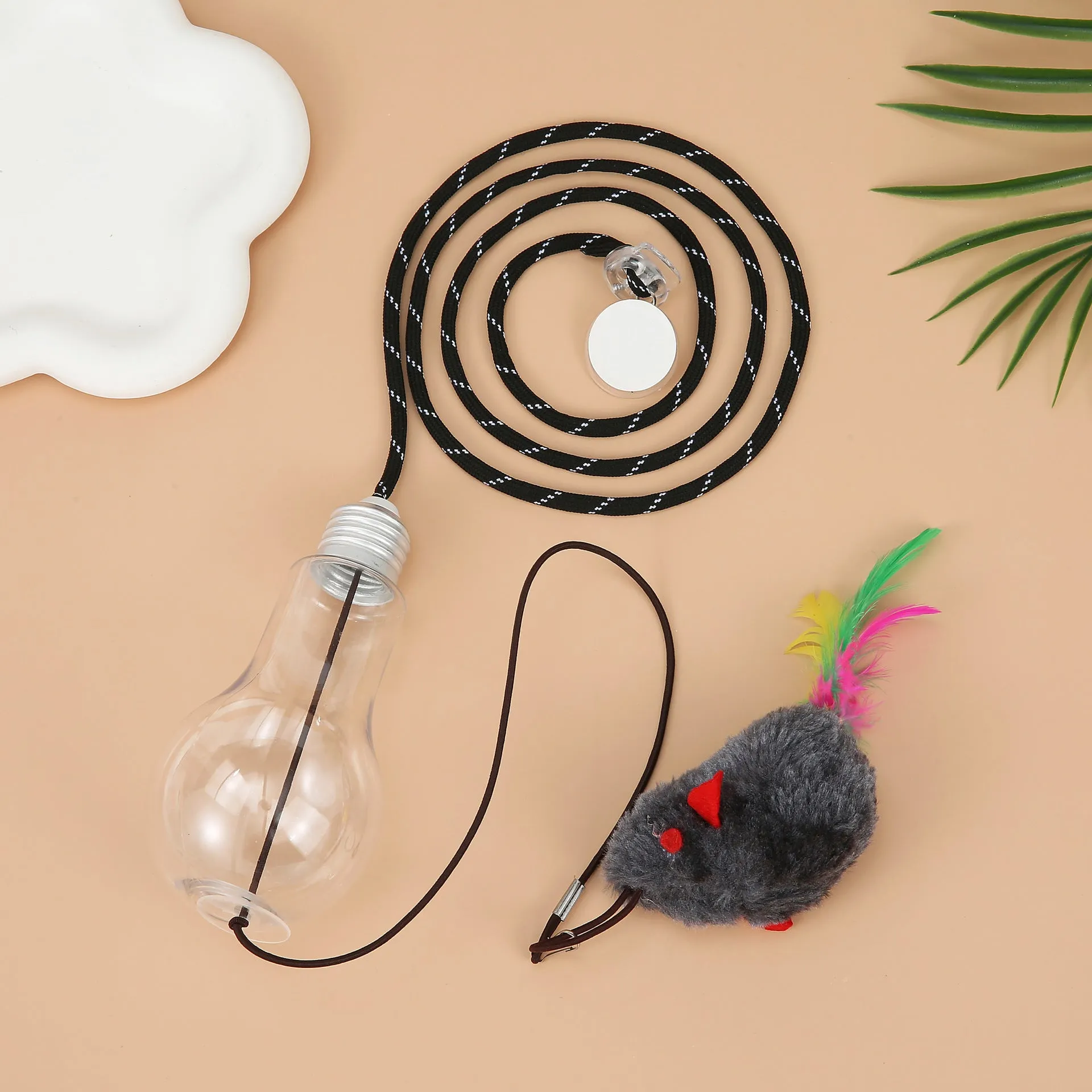 Interactive hanging cat toy with retractable elastic rope and treat reward bulb mounted on door frame