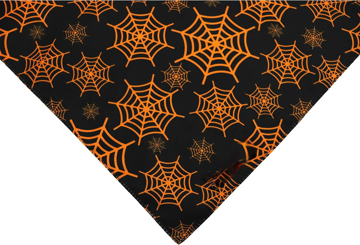 Reversible Halloween dog bandana showing pumpkin design on one side and spider web pattern on the other