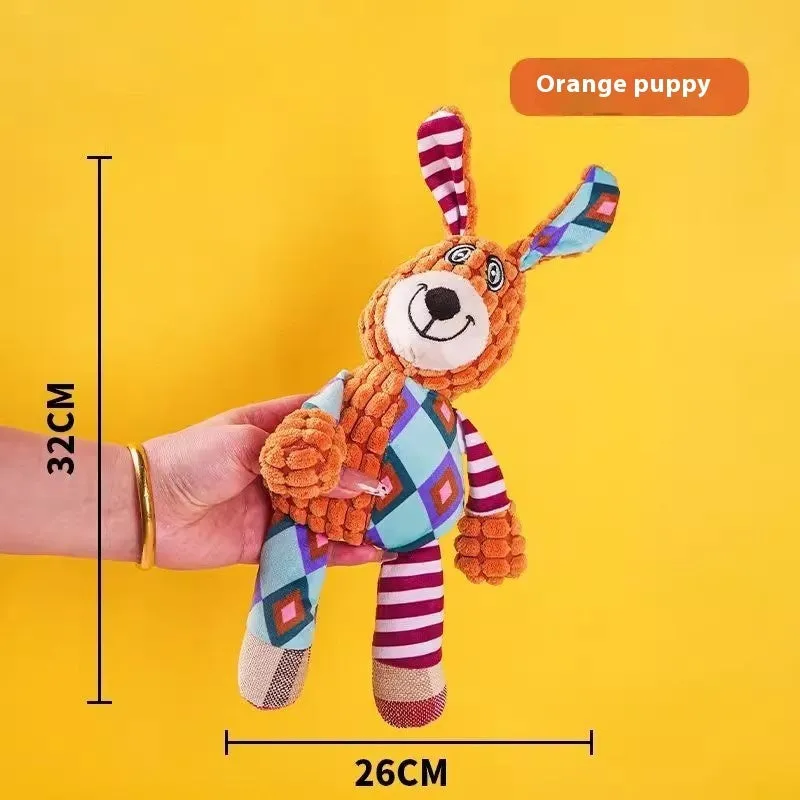Assorted plush dog toys including a pink-gray donkey, a beige donkey, a blue elephant, and yellow ducks in three sizes.