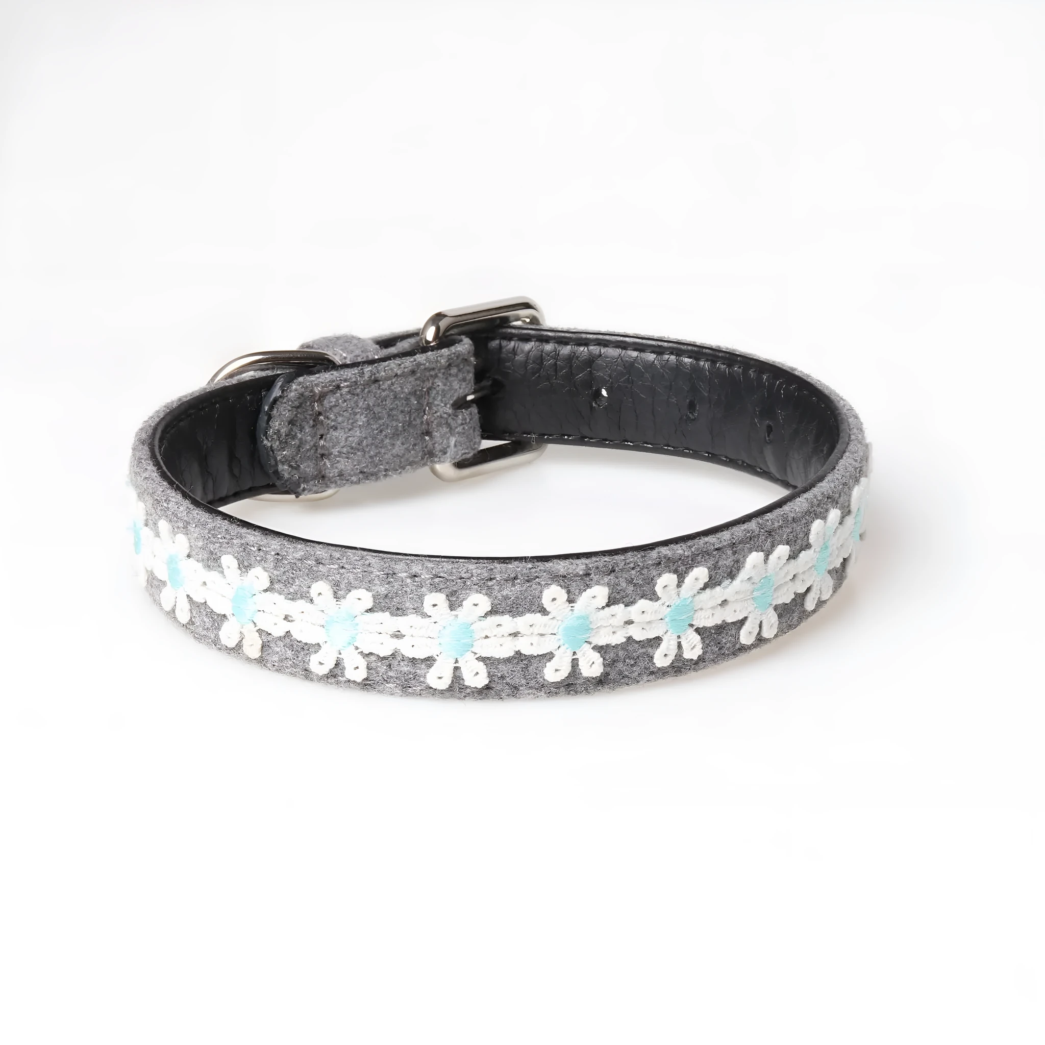 Embroidered PU dog collar with metal buckle on a neutral background, available in four colours and two adjustable sizes