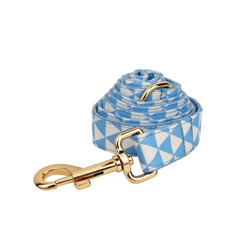 Blue triangular ring on a cloth dog collar and lead set with matching bow and vest, shown in a four-piece pet accessory package.