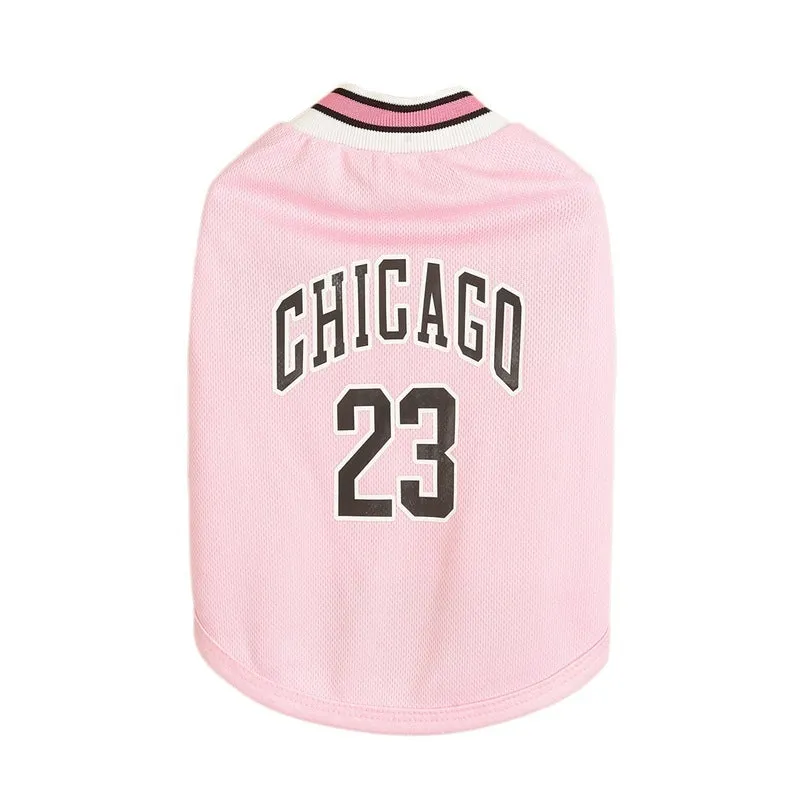 Dog wearing a black mesh polyester basketball vest with number 23 print, side view