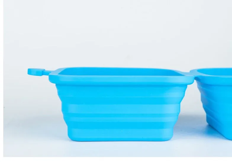 Foldable silicone double pet bowl for dogs and cats in green with two compartments for food and water