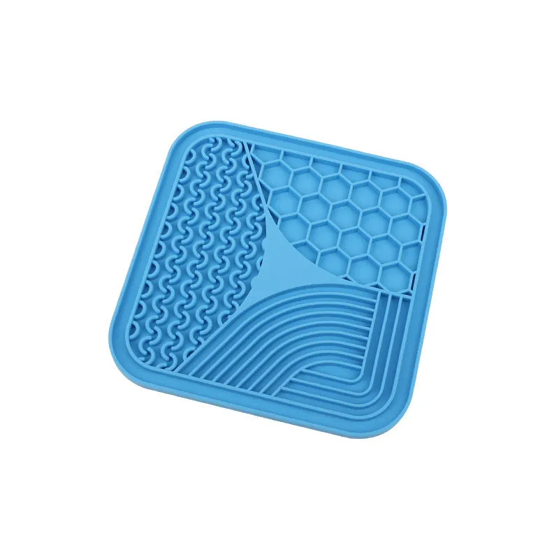 Gray silicone anti-choke slow feeding dog licking pad with textured surface on a flat surface