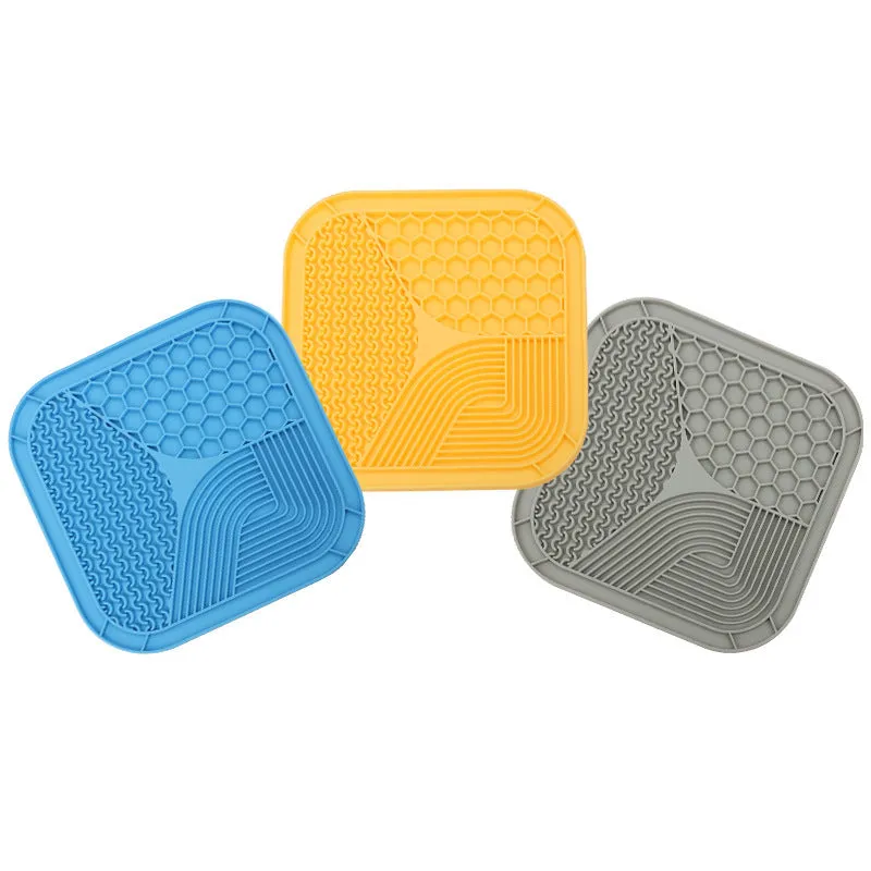 Gray silicone anti-choke slow feeding dog licking pad with textured surface on a flat surface