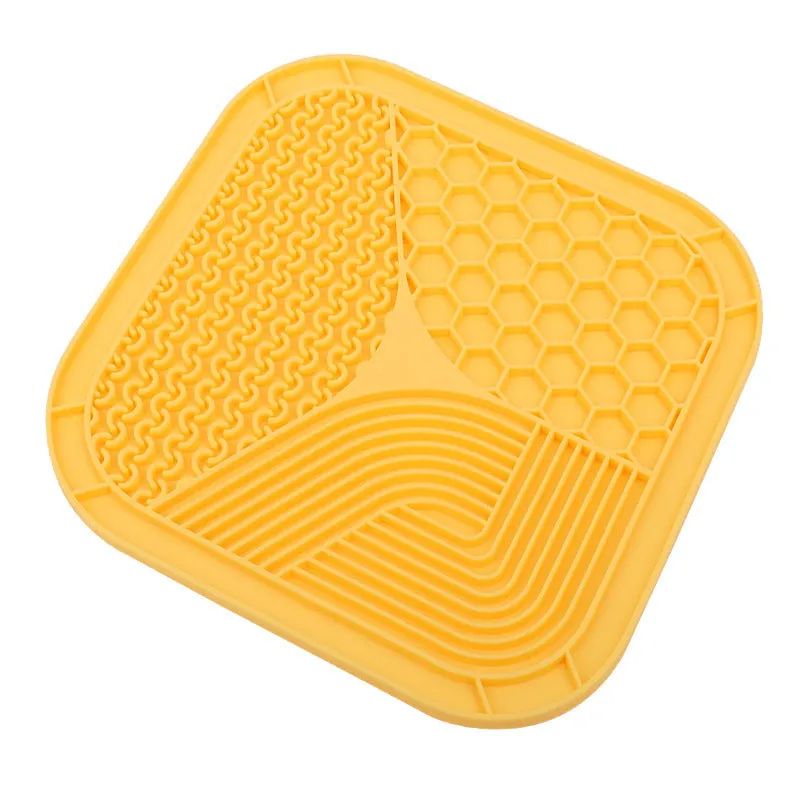 Gray silicone anti-choke slow feeding dog licking pad with textured surface on a flat surface