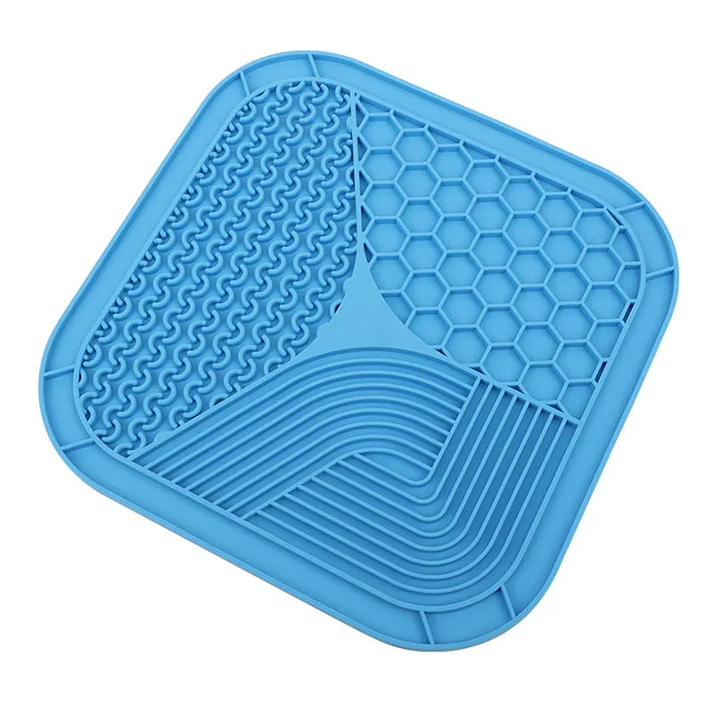 Gray silicone anti-choke slow feeding dog licking pad with textured surface on a flat surface