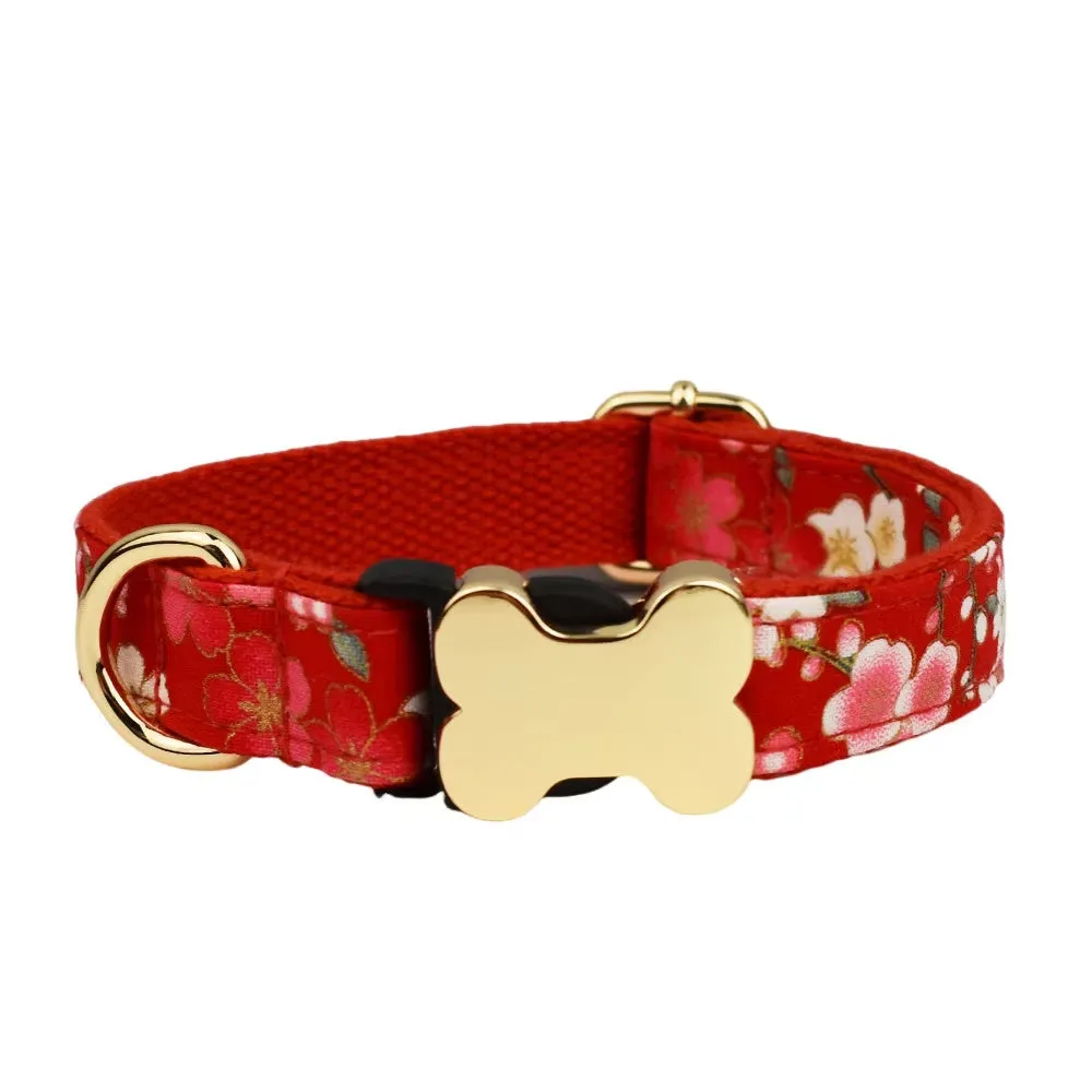 Flat nylon dog collar with grid print and a silver bone-shaped metal buckle on a green background.