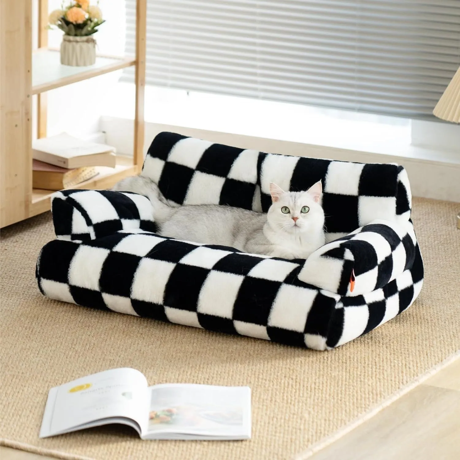 Fluffy cat couch bed in black and white with raised sides and non-slip base for cats and small dogs