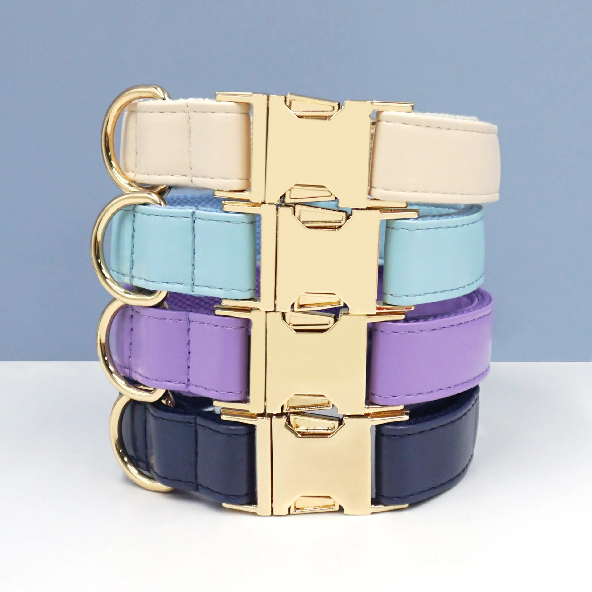 Leather dog collar with velvet texture section in colour block design, shown on a buckle.